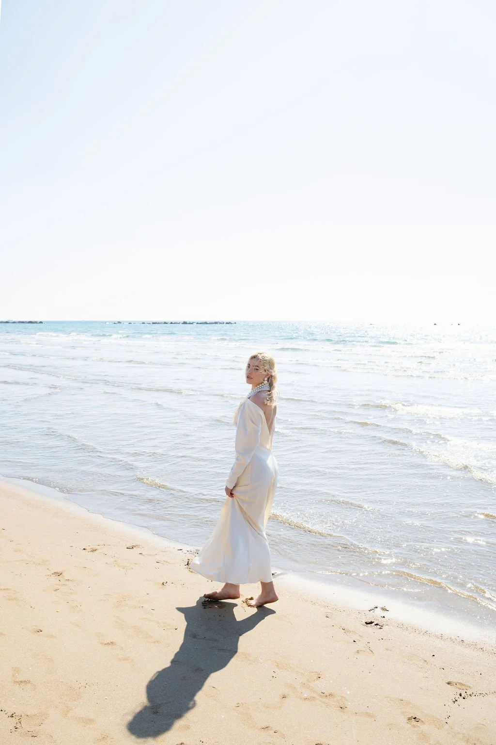 sarapaolucci-bride-walking-on-the-beach-barefoot.jpg