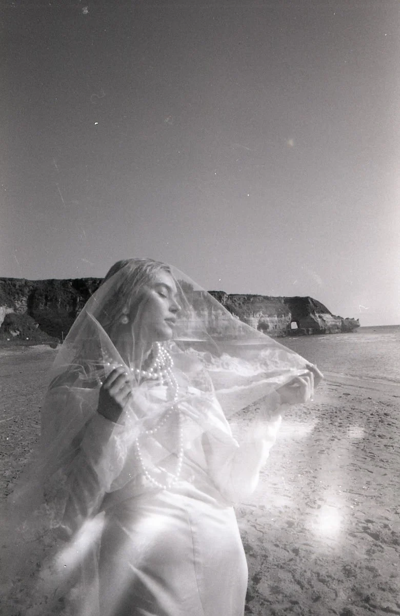 sarapaolucci-film-photo-portrait-of-a-bride-touching-her-veil.jpg