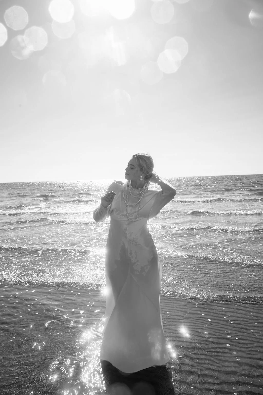 sarapaolucci-bride-portrayed-in-the-sea-wearing-her-wedding-dress.jpg