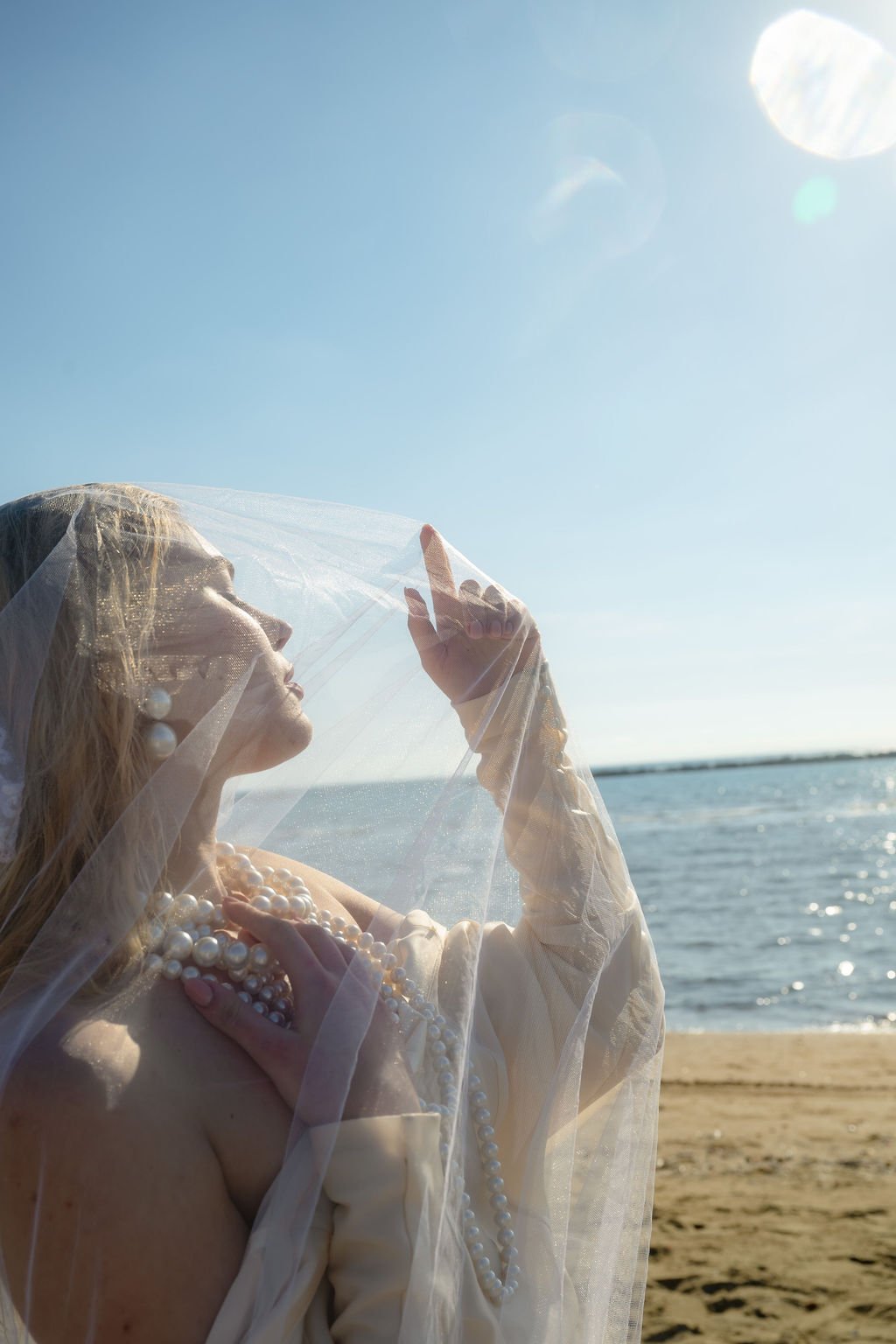 sarapaolucci-bride-playing-with-veil-on-the-beach.jpg