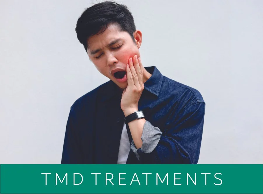 Young man holding his cheek in pain, red and swollen, appears to have a toothache, with a sign that says 'TMD Treatments' at the bottom.