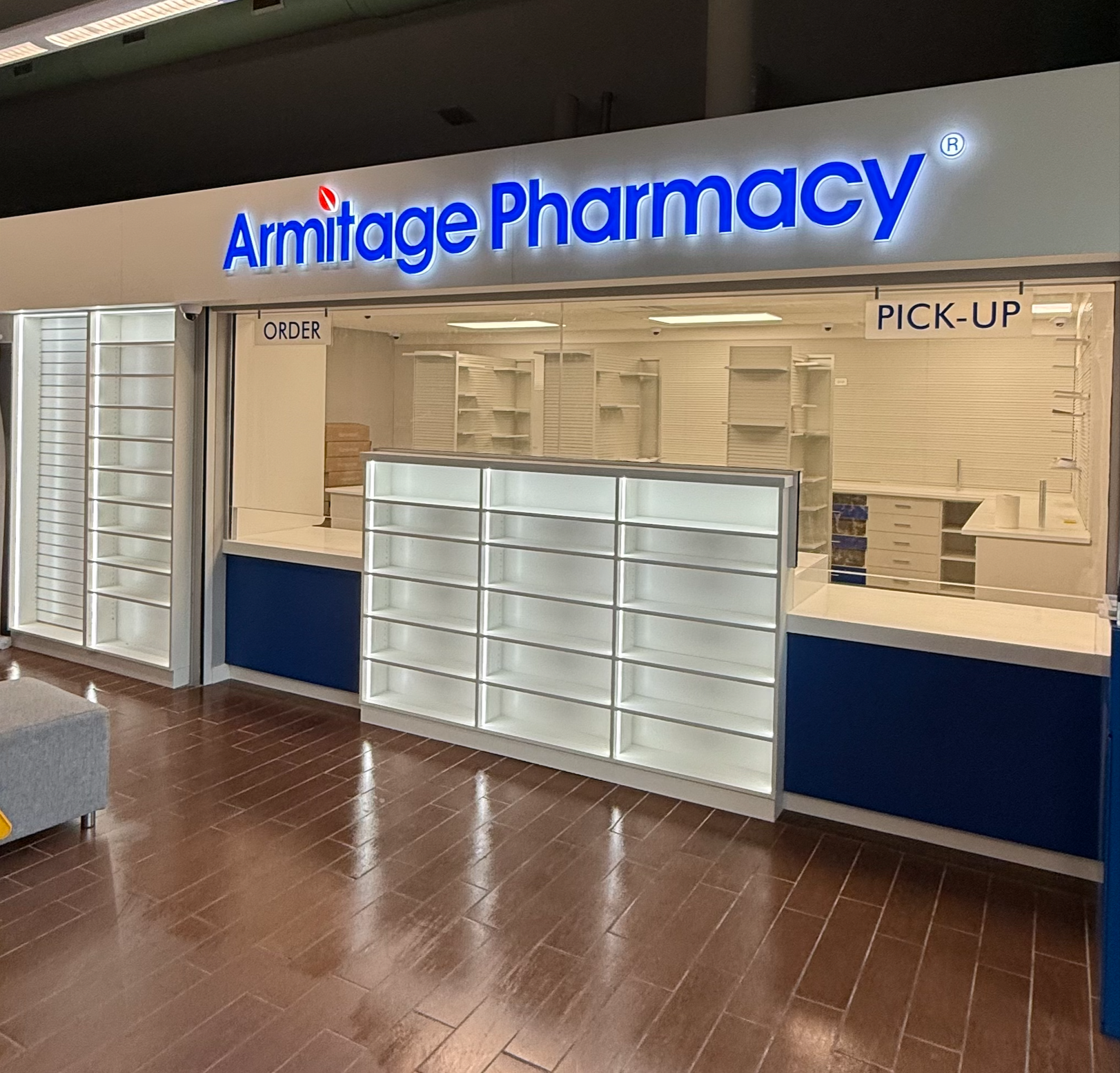 Armitage Pharmacy front counter with custom white shelving and blue base cabinets