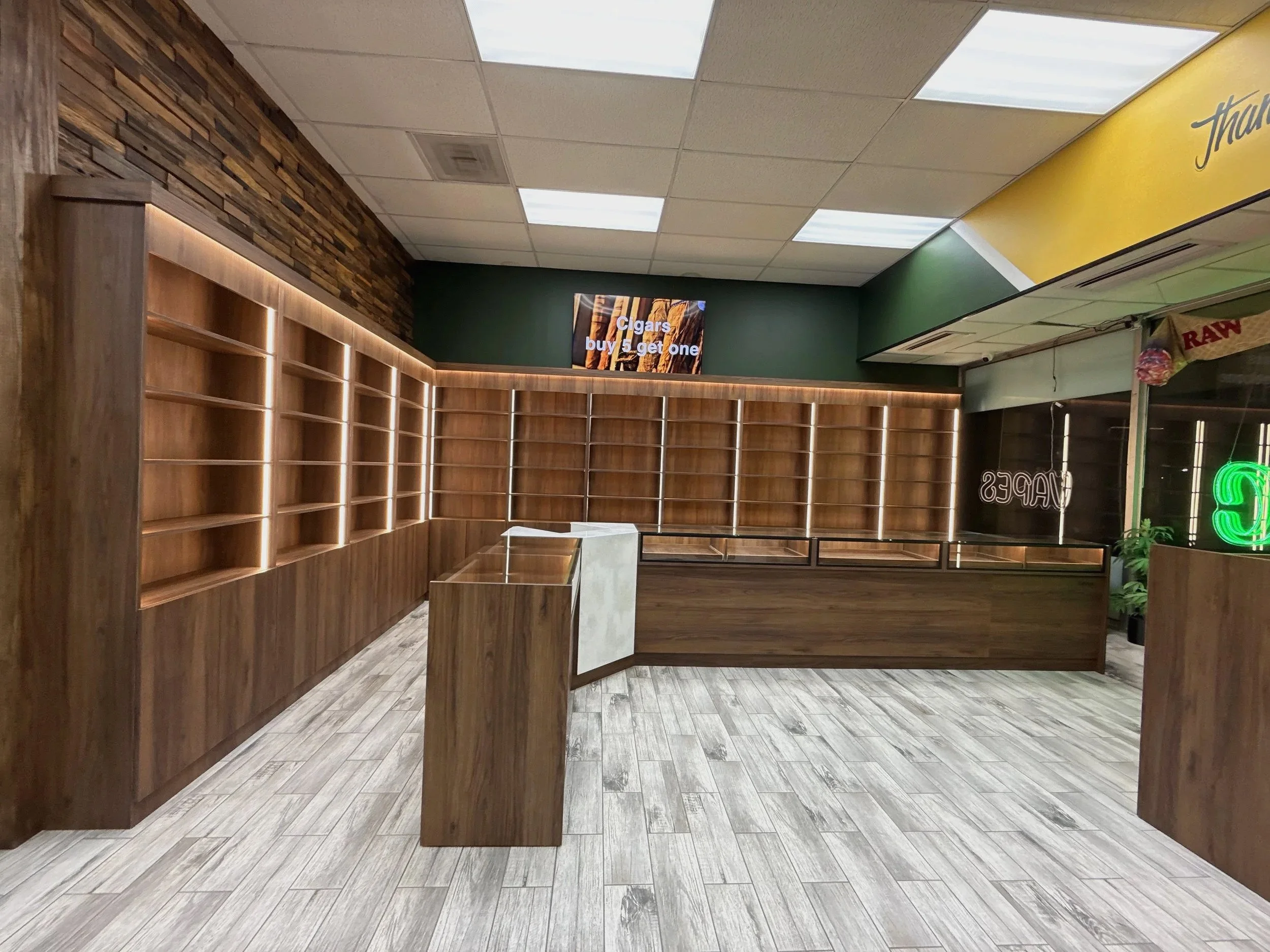 Retail store interior with full-height wood display shelving and front counter