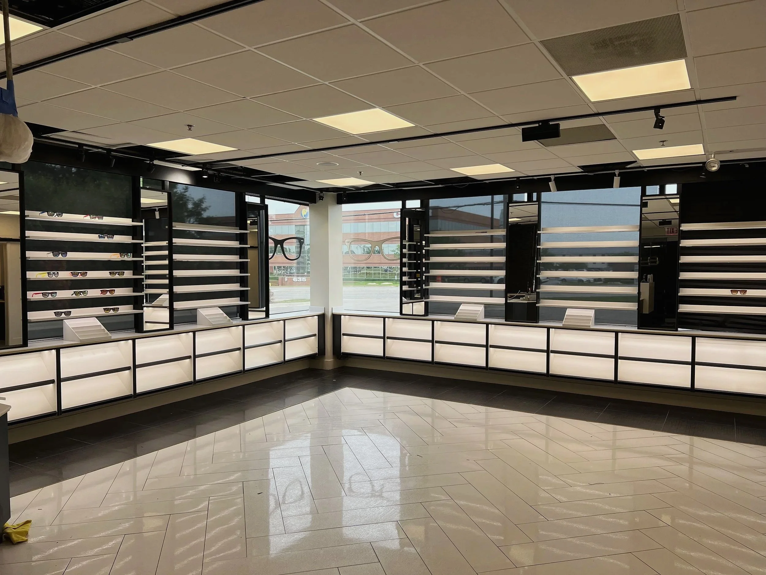 Retail showroom with illuminated wall displays and glossy tile floor