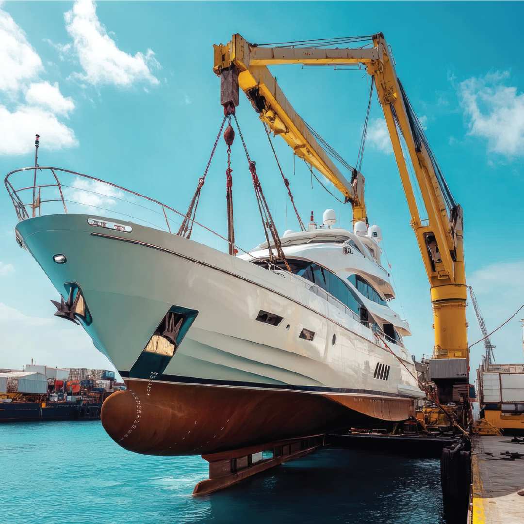 A large yacht is being lifted by a yellow crane at a dock with water and other ships in the background.