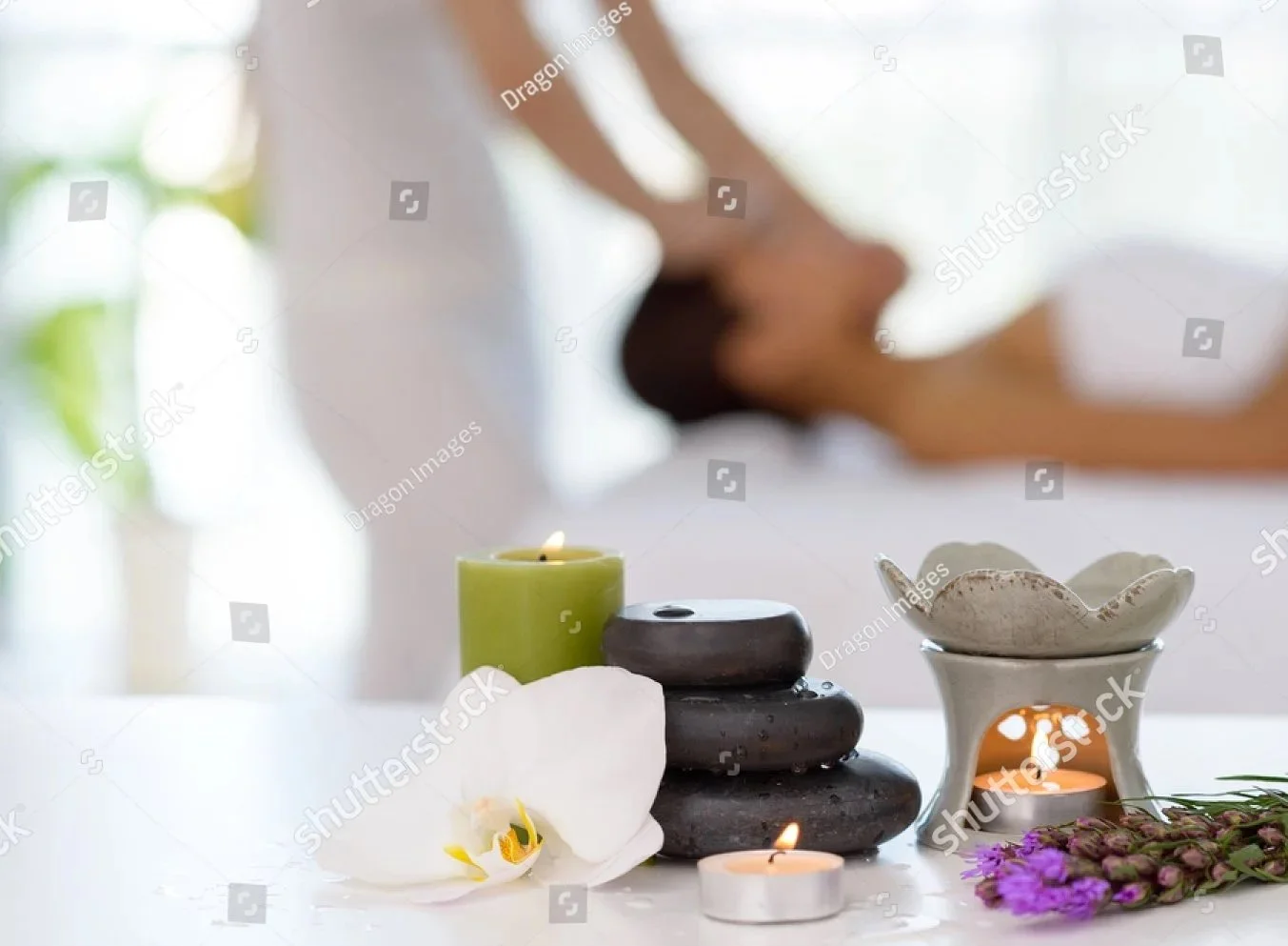 stock-photo-spa-concept-zen-stones-candles-and-flowers-on-the-background-of-woman-receiving-treatment-232040587.jpg
