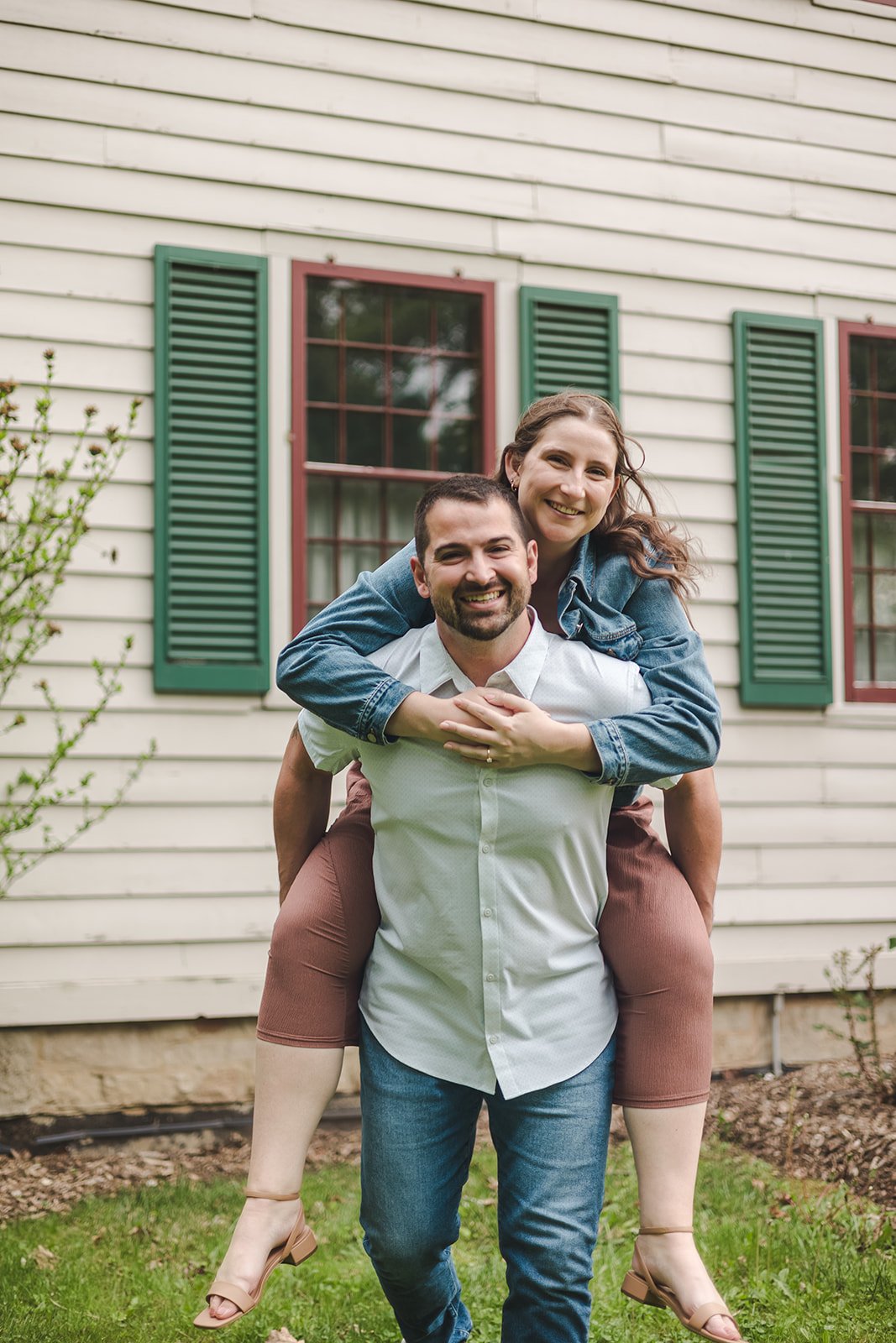 Couple smiling during piggyback ride  Ontario Engagement  Fedora Media.jpg