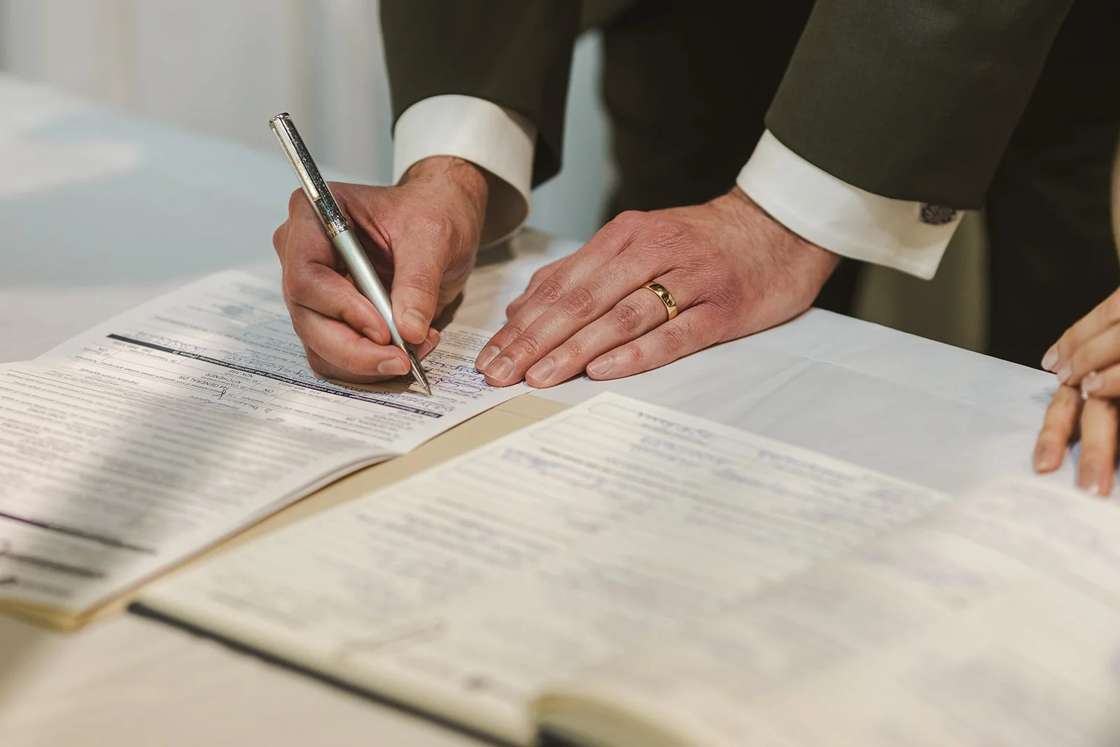 Detail moment of Groom's hands while signing wedding certificate  Kitchener, ON  THE museum  Fedora Media.jpg