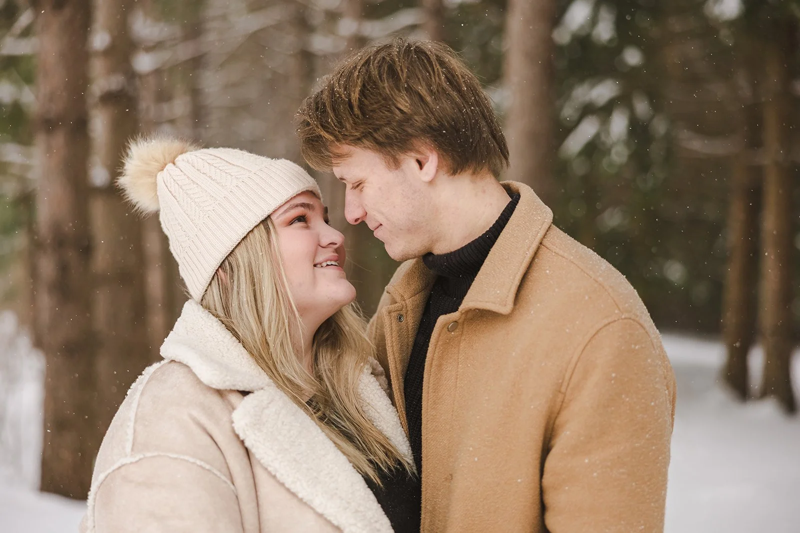 Couple embracing in snowy forest  Ontario Engagement  Fedora Media.jpg
