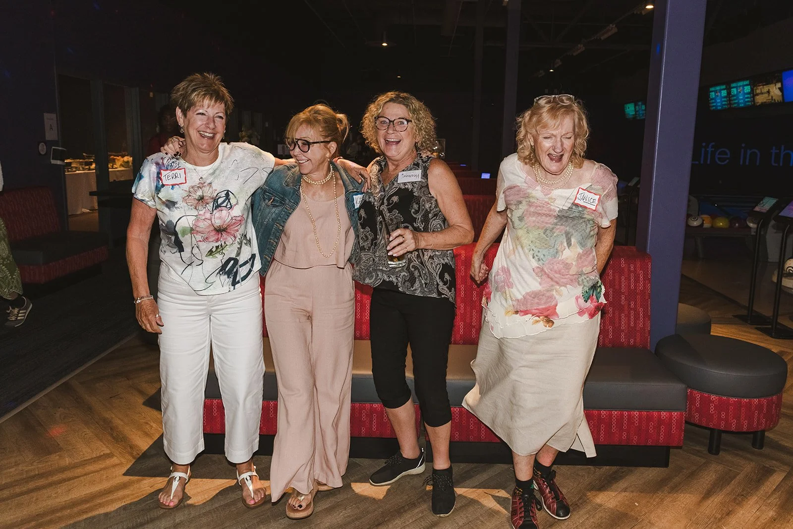 Female wedding guests dancing in bowling alley  bowling alley wedding Fedora Media..jpg