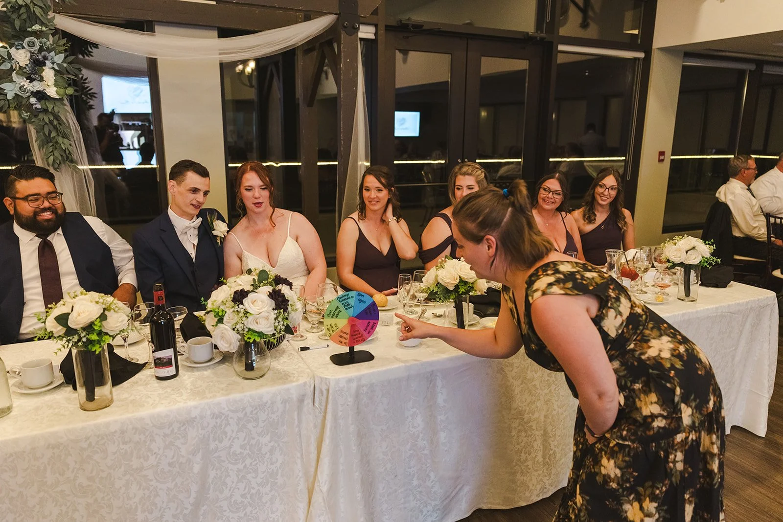 Wedding guest spinning wheel to get bride and groom to kiss  Golf Course Wedding  Fedora Media.jpg