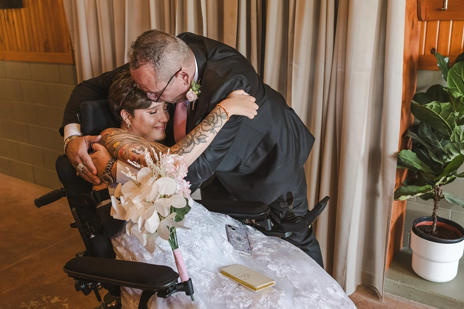 Dad hugging bride in wheelchair  Pine Valley Chalet  Kitchener, ON  Fedora Media.jpg