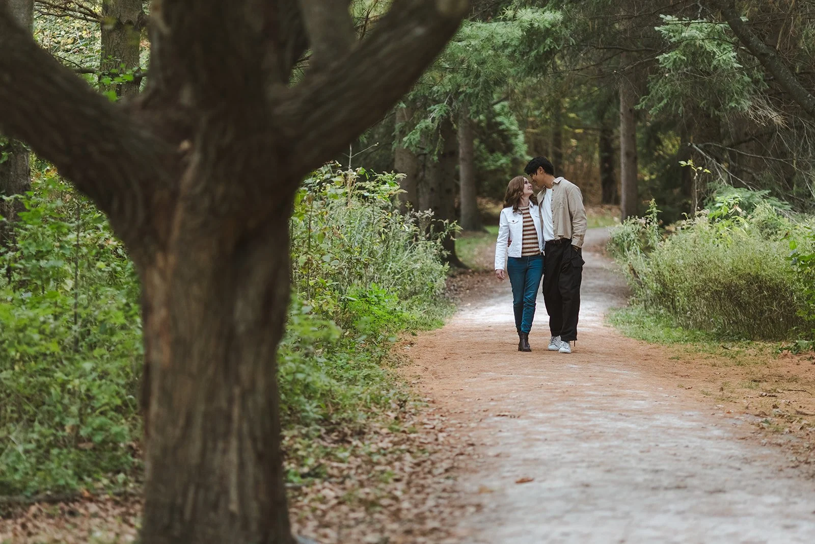 Couple embracing and walking in park  Ontario Engagement  Fedora Media.jpg