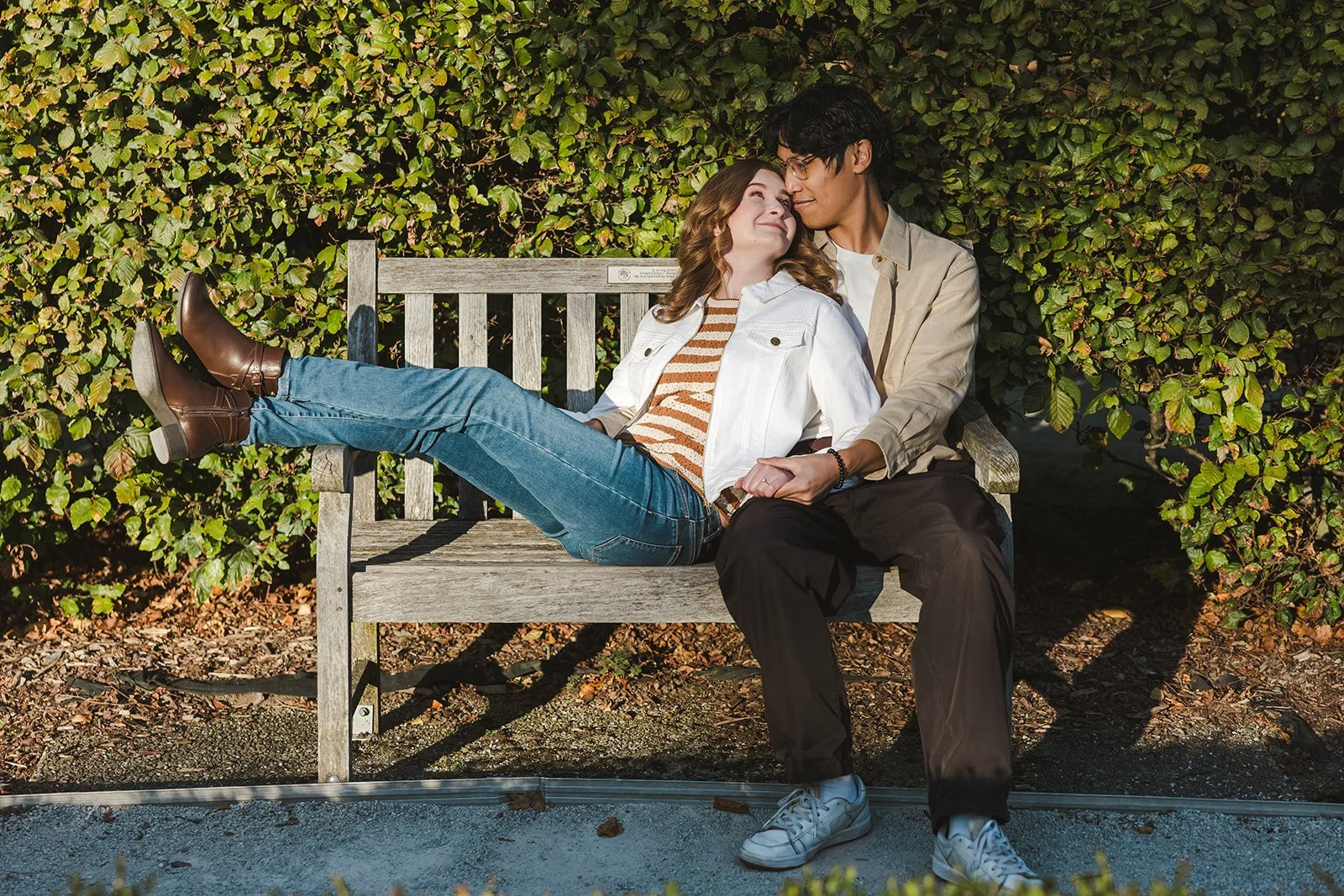 Couple sitting on park bench in fall  Ontario Engagement  Fedora Media.jpg