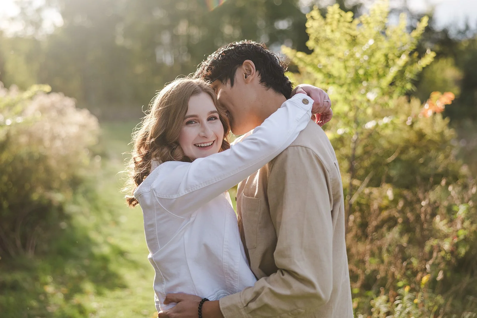 Man kissing woman's cheeck while she smiles  Ontario Engagement  Fedora Media.jpg