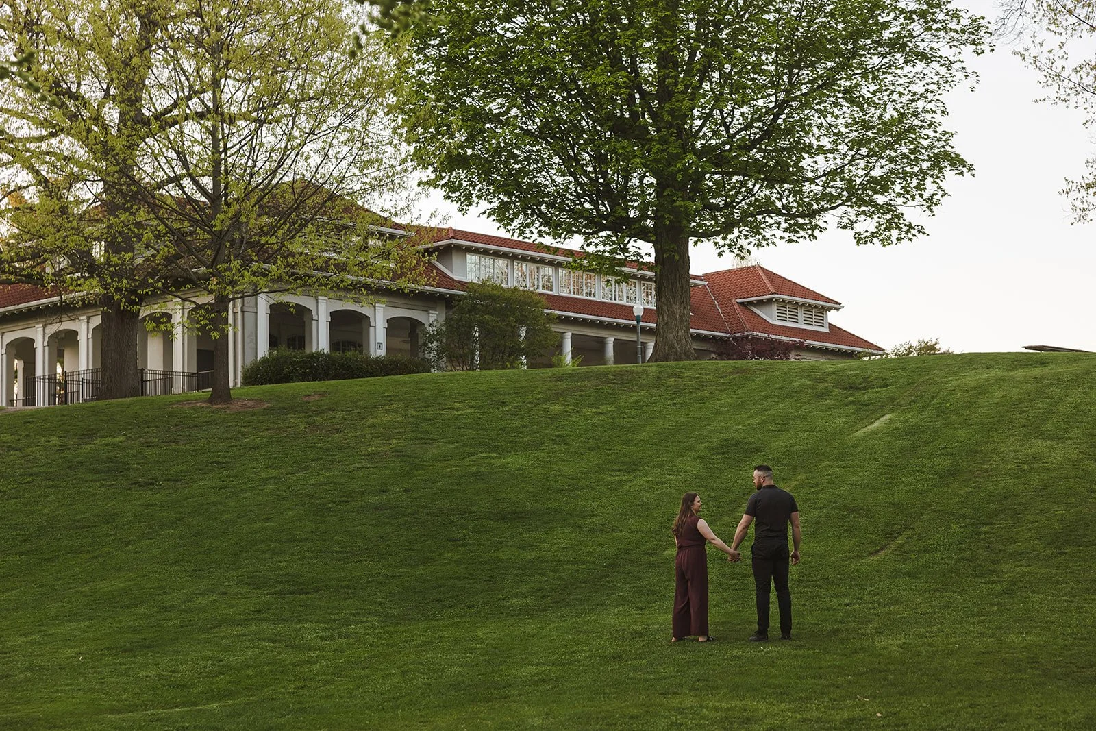 Couple holding hands walking up hill  Ontario Engagement  Fedora Media.jpg