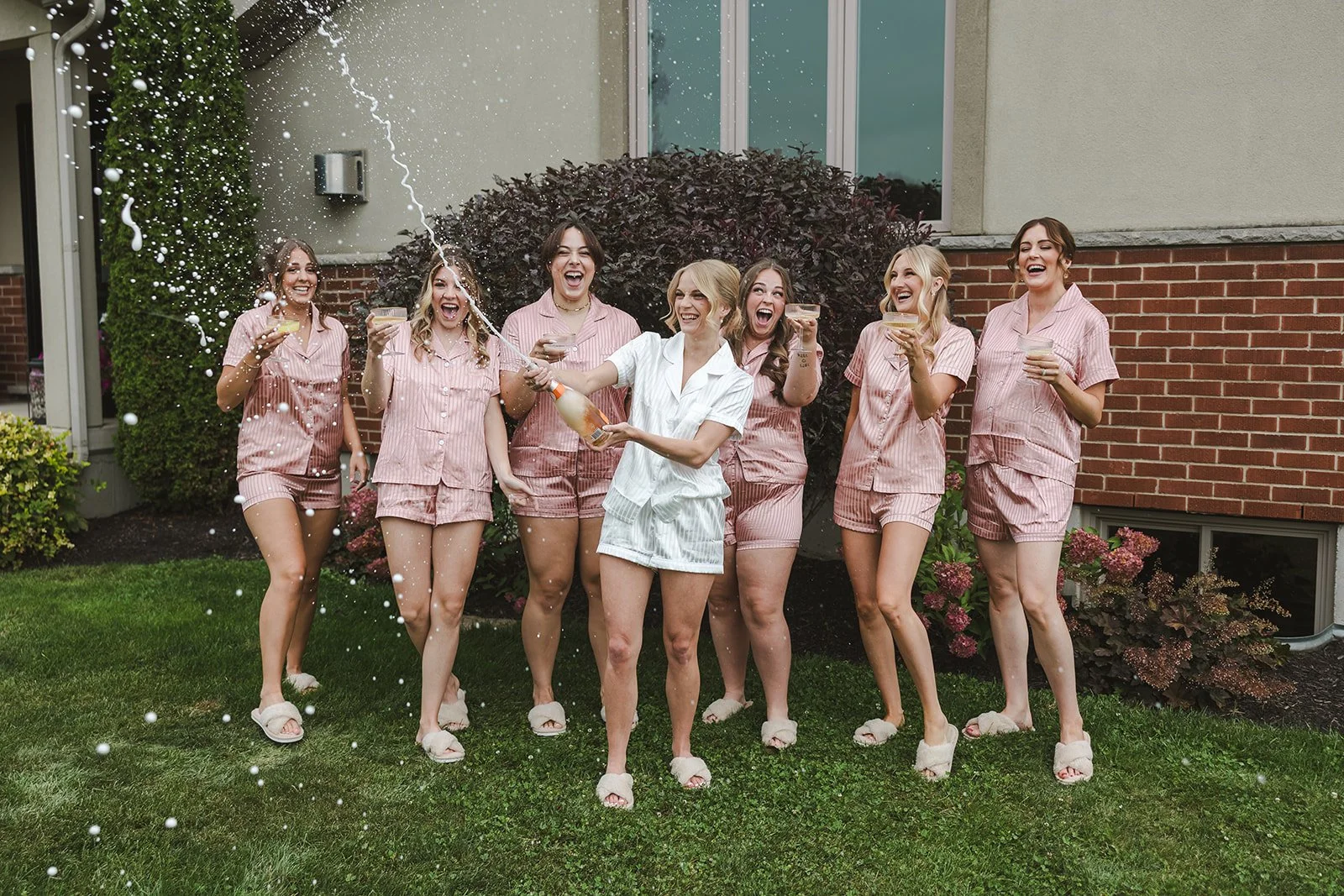 Bride popping champagne with bridemaids outside  Straford, ON  Fedora Media.jpg