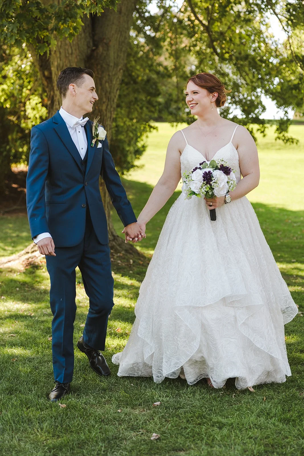 Bride and groom walking holding hands  Golf Course Wedding  Fedora Media.jpg