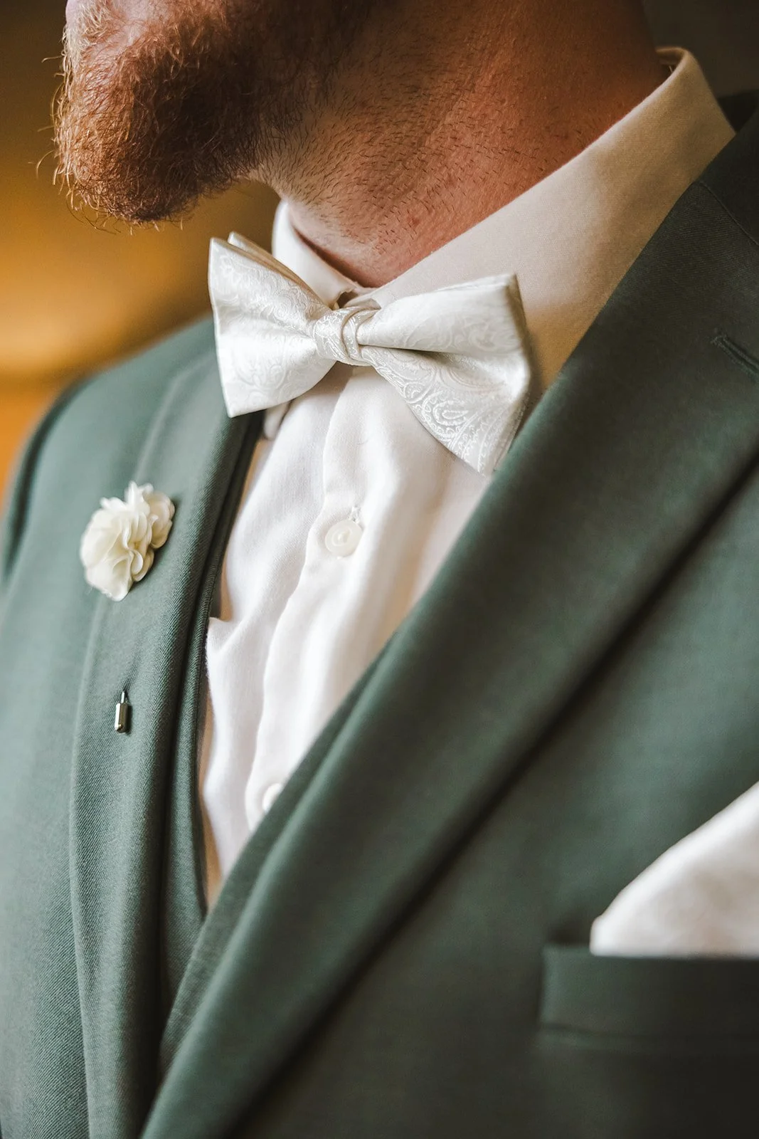 Close of white tie with green suit jacket  fall wedding  Fedora Media.jpg