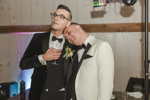 same+sex+wedding+candid+moment+of+two+grooms+photo+by+Fedora+Media.webp