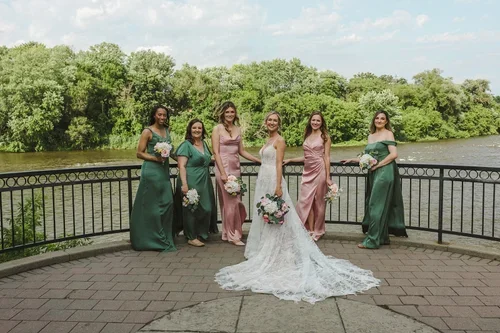 Bride+with+bridesmaids+in+pink+bridesmaid+and+green+bridesmaid+dresses+photo+by+Fedora+Media.webp