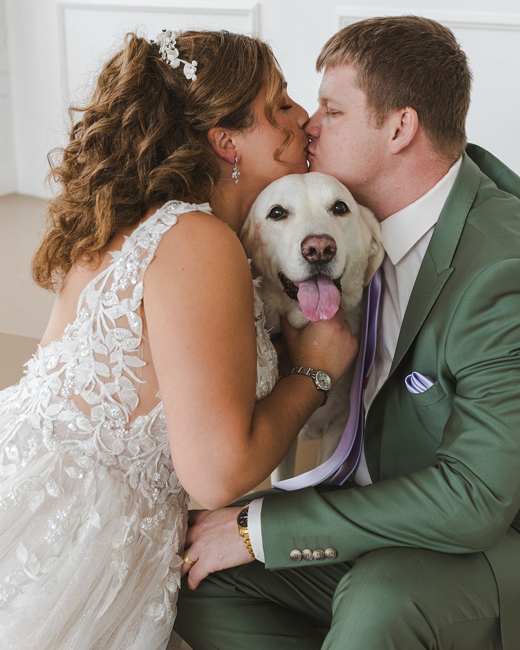 Wedding Photo of the Month goes to Lori!

We are absolutely melting over this shot. There is nothing sweeter than a bride, a groom, and their fur baby!

Lori captured the perfect moment of the happy couple stealing a kiss over their pup (who clearly 
