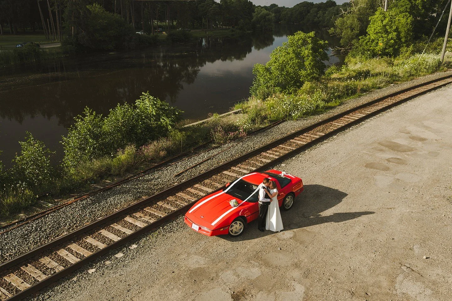 Taking wedding portraits to a whole new level! Nothing beats a stunning golden hour couple shot paired with a classic Corvette, all captured from high above by drone. Talk about driving off into forever in style! 

#WeddingPhotography #DronePhotograp