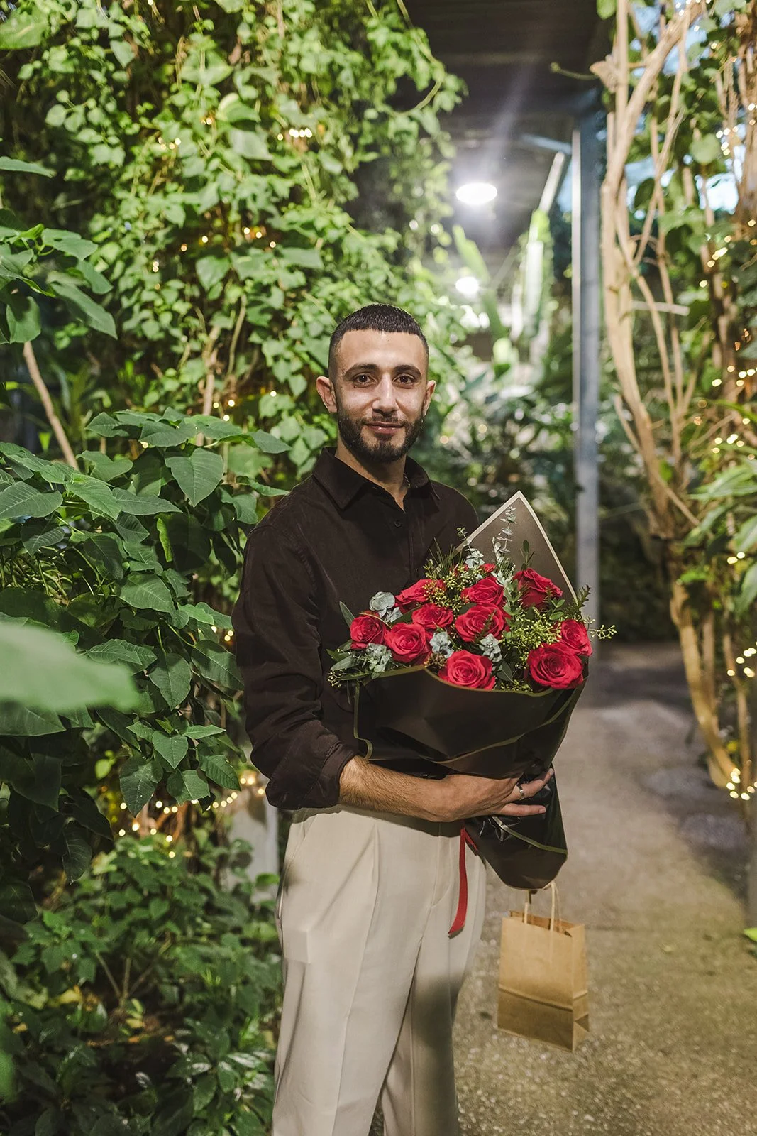 Man holding red rose bouquet  Proposal  Cambridge Butterfly Conservatory  Cambridge, ON  Fedora Media.jpg