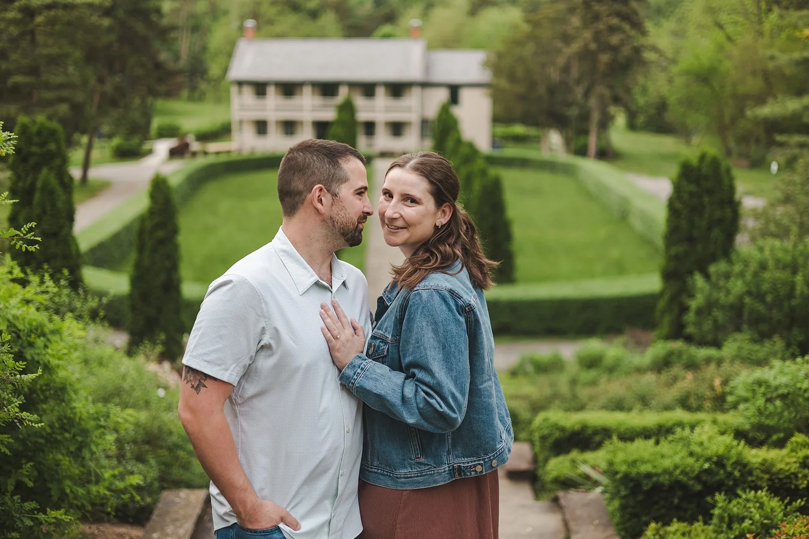 Couple embracing on hill with women looking into camera  Ontario Engagement  Fedora Media.jpg