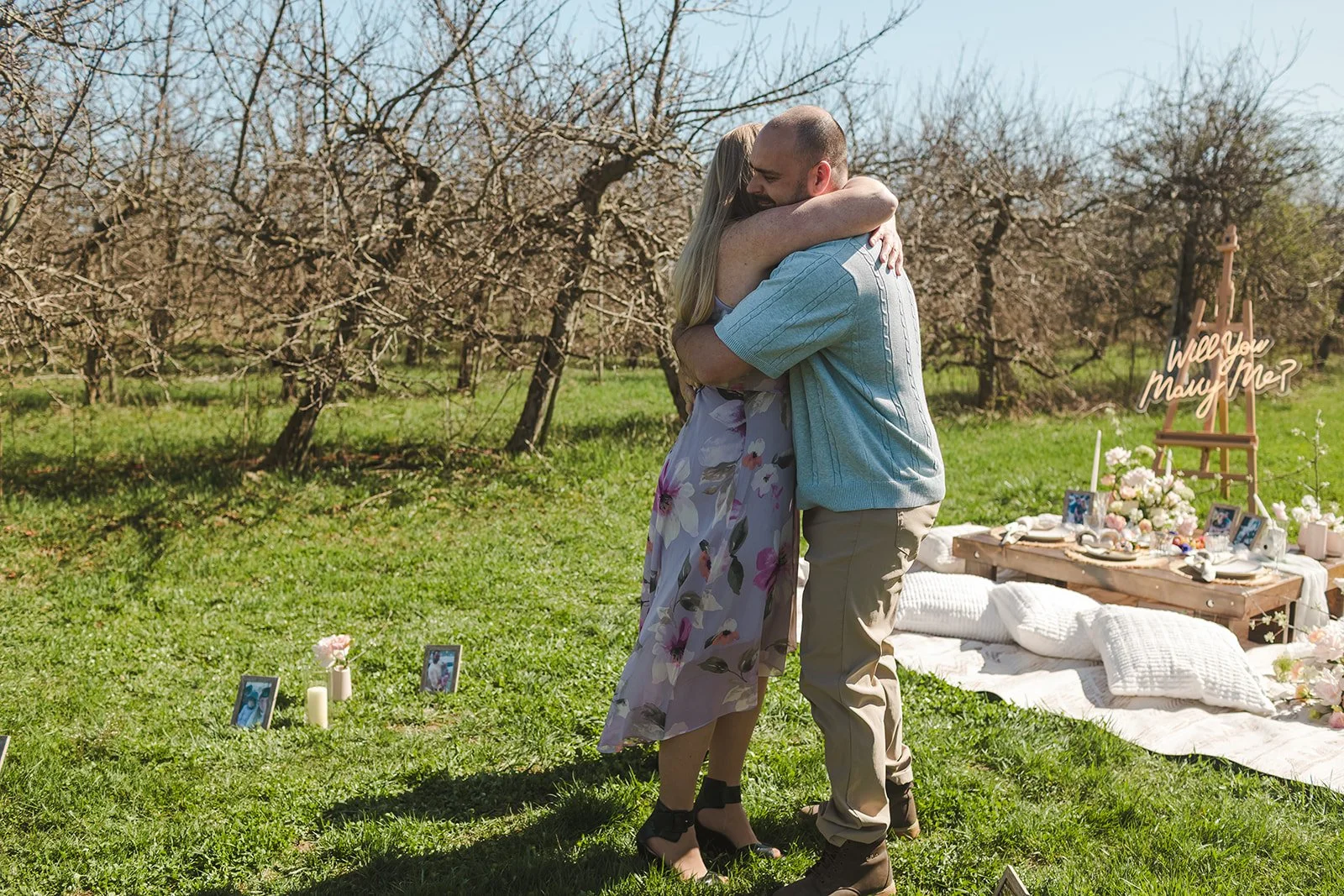 Couple hugging in orchard before picnic  Orchard Propsal  Fedora Media.jpg