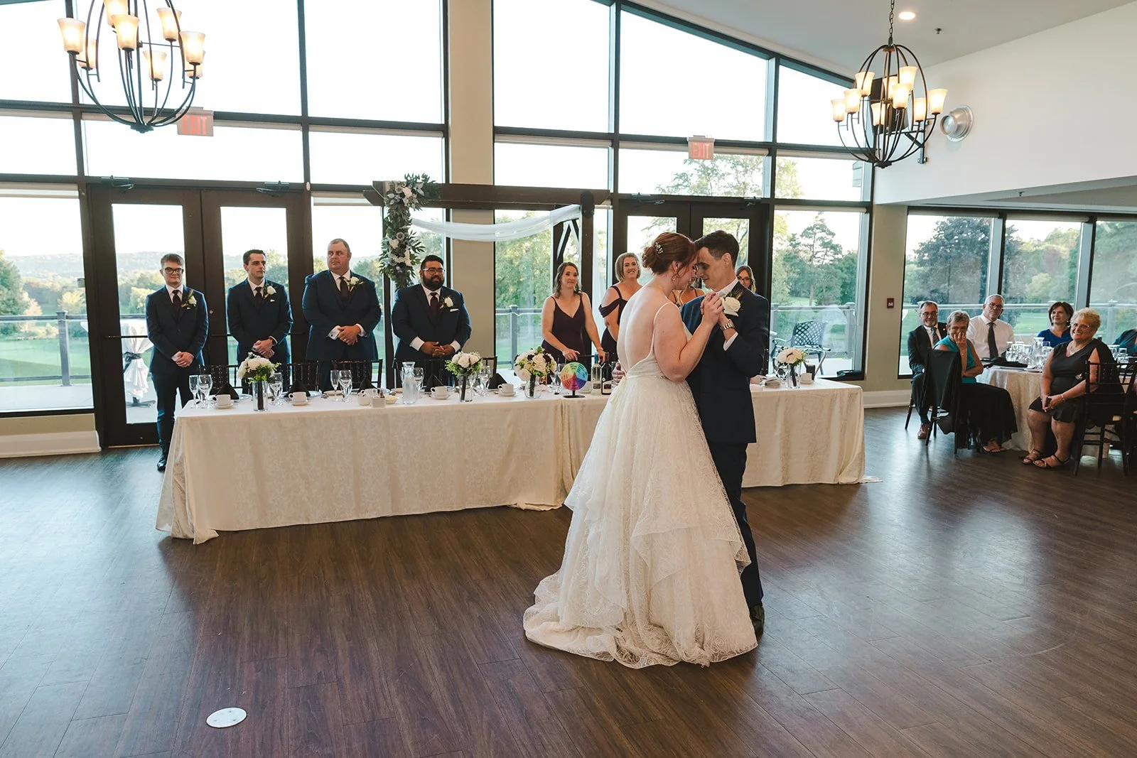 Bride and groom share first dance in front of head table  Golf Course Wedding  Fedora Media.jpg