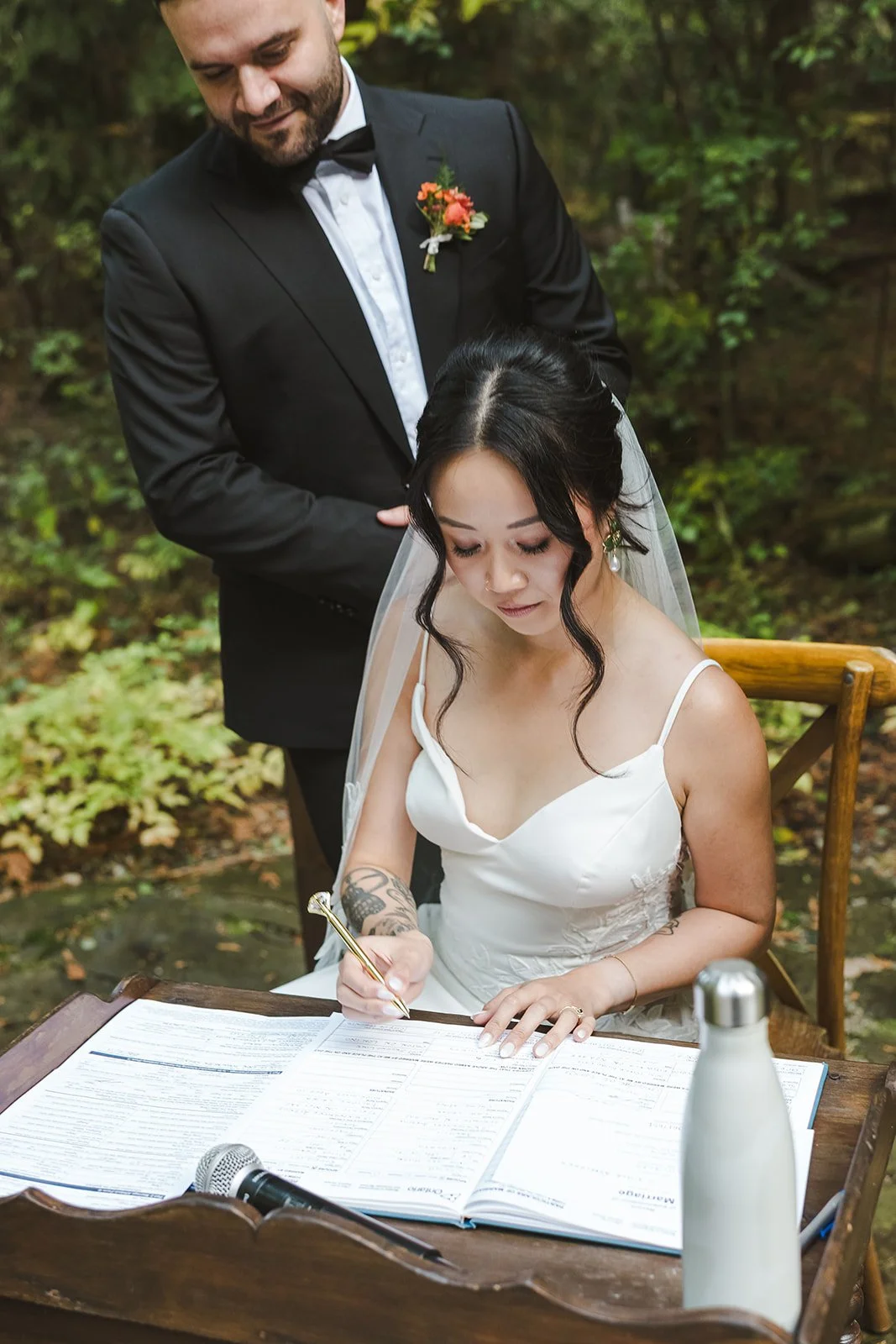 Bride and groom at signing table  Erin Estates  Fedora Media.jpg