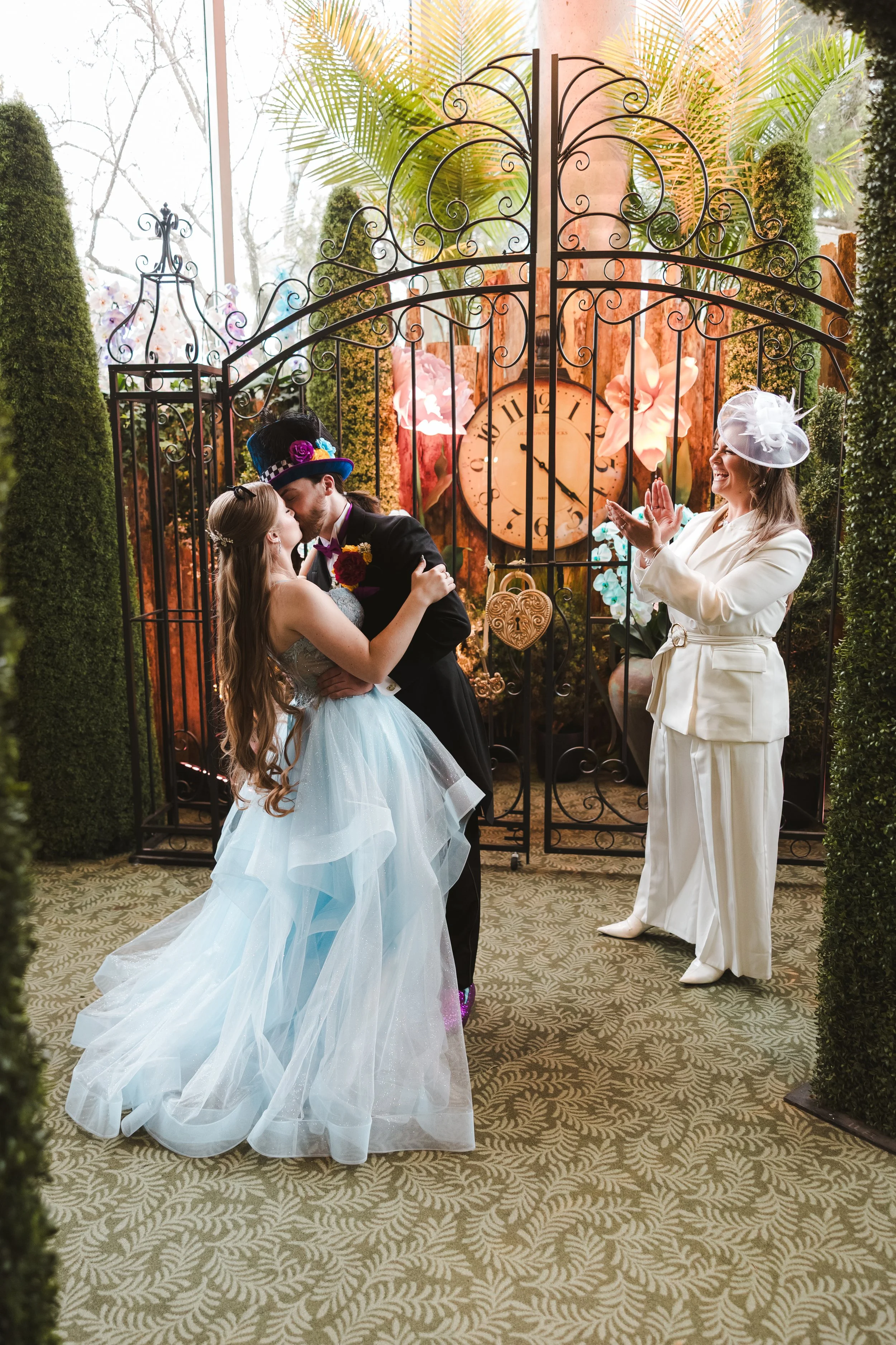 bride-and-groom-embrace-alice-in-bloomland-fedora-media.jpg