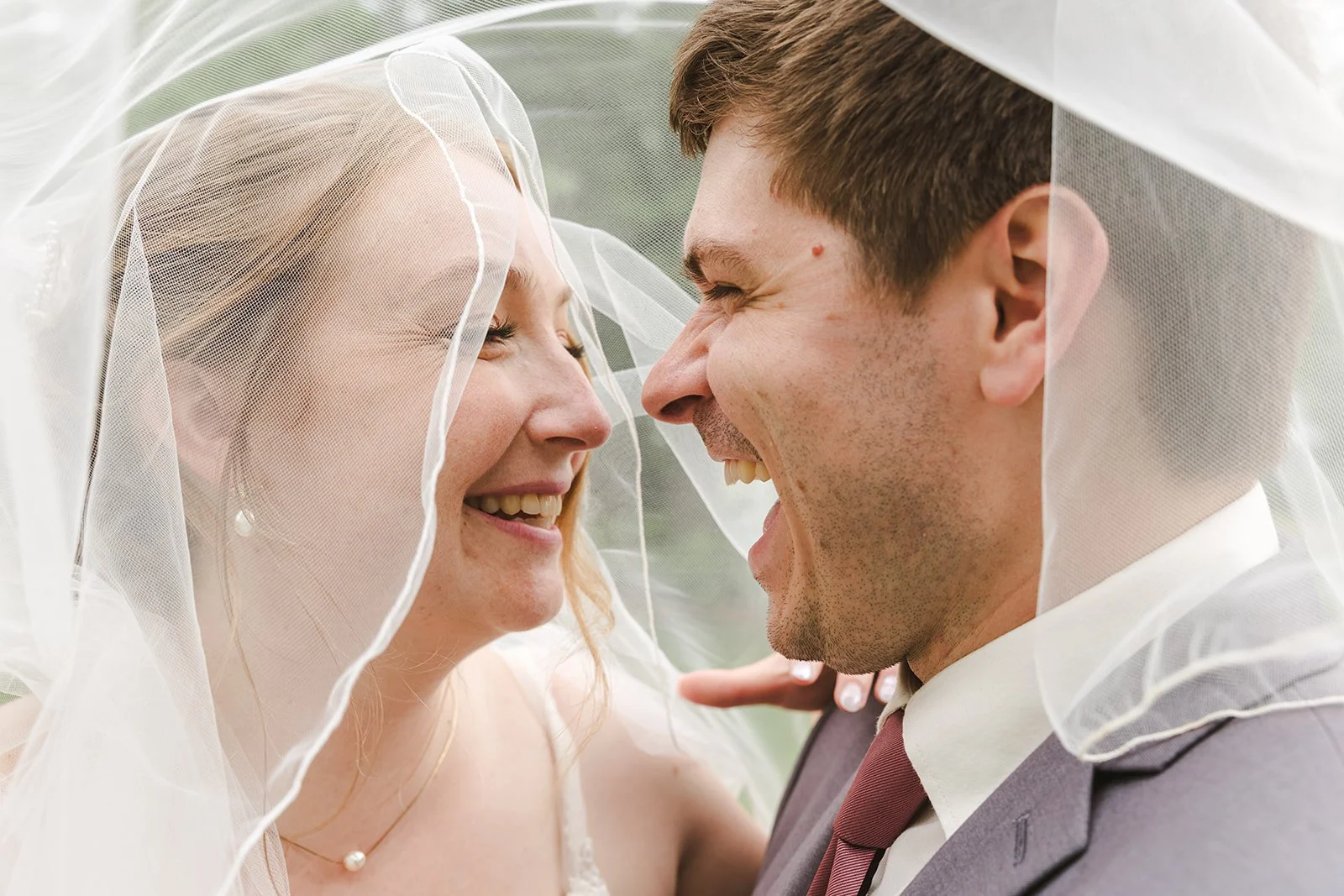 Bride and groom laughing under veil  Boho Wedding  Fedora Media.jpg