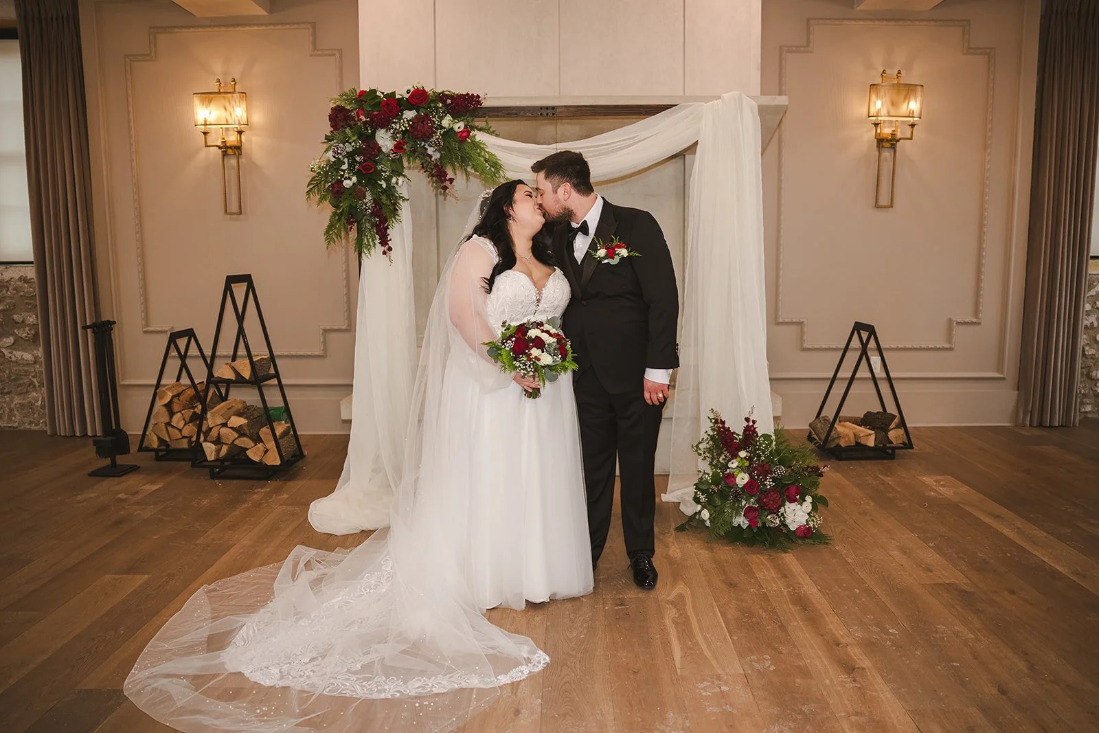 Bride and groom kissing in front of fireplace  Elora Mill  Elora, ON  Fedora Media.jpg
