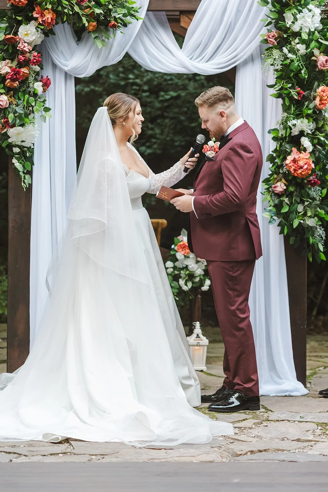 Bride holding microphone at altar for groom  Erin Estates  Fedora Media.jpg