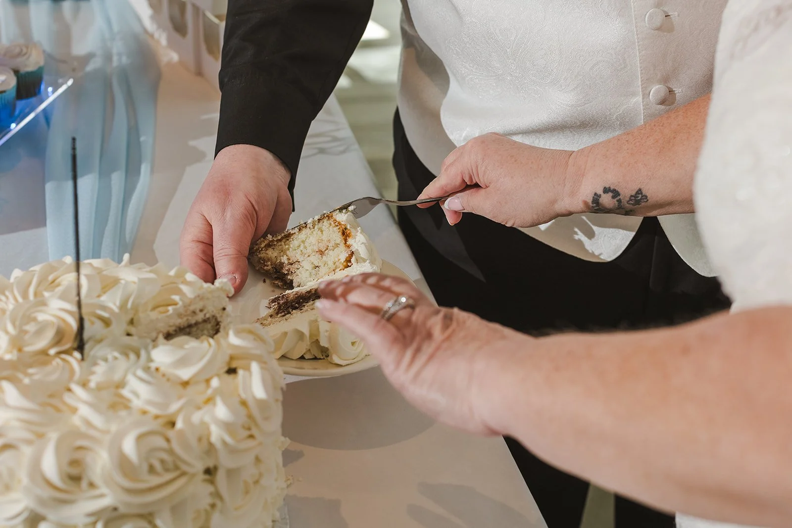 Bride and Groom serving slice of wedding cake  Cambridge Hotel  Cambridge, ON  Fedora Media.jpg