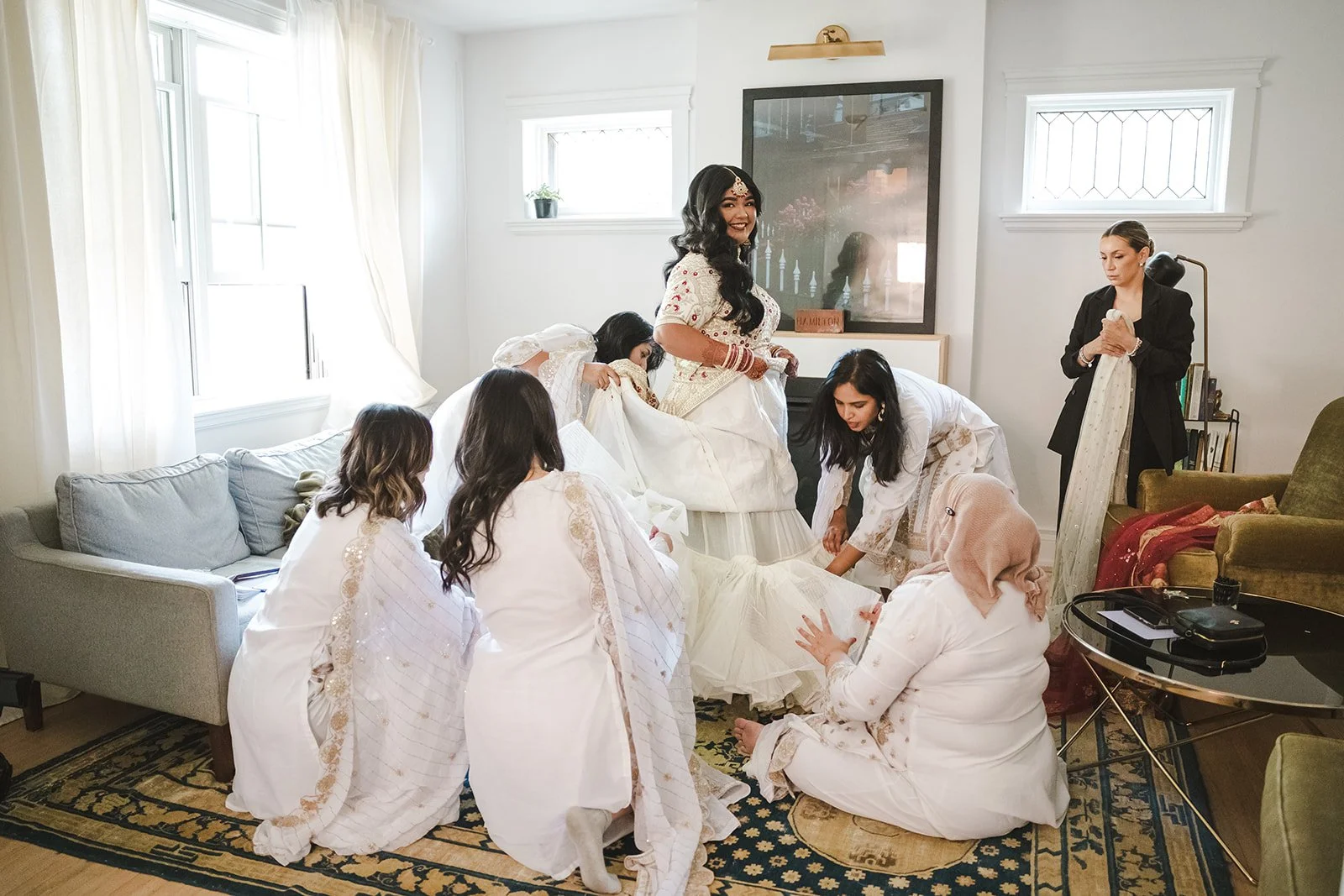 Bridesmaids helping Bride get into Lehenga Choli  Hamilton, ON  Royal Hamilton Yacht Club  Fedora Media .jpg