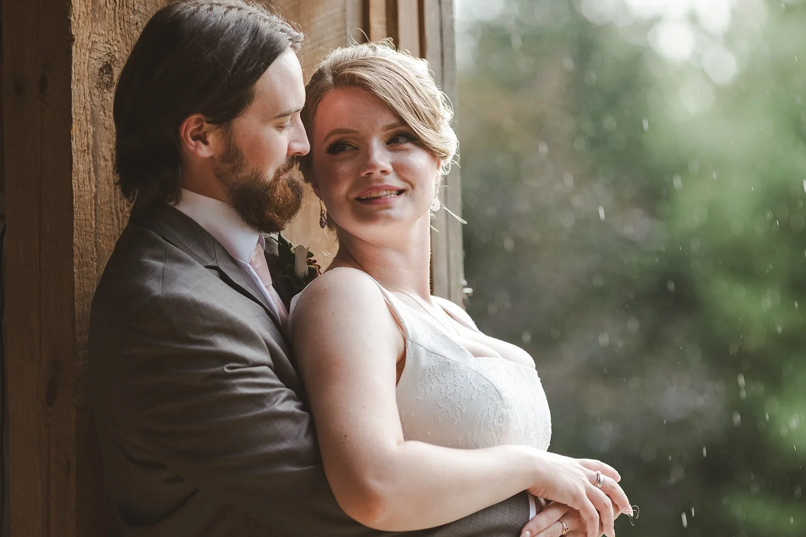 cute candid moment watching the rain on wedding day.jpg