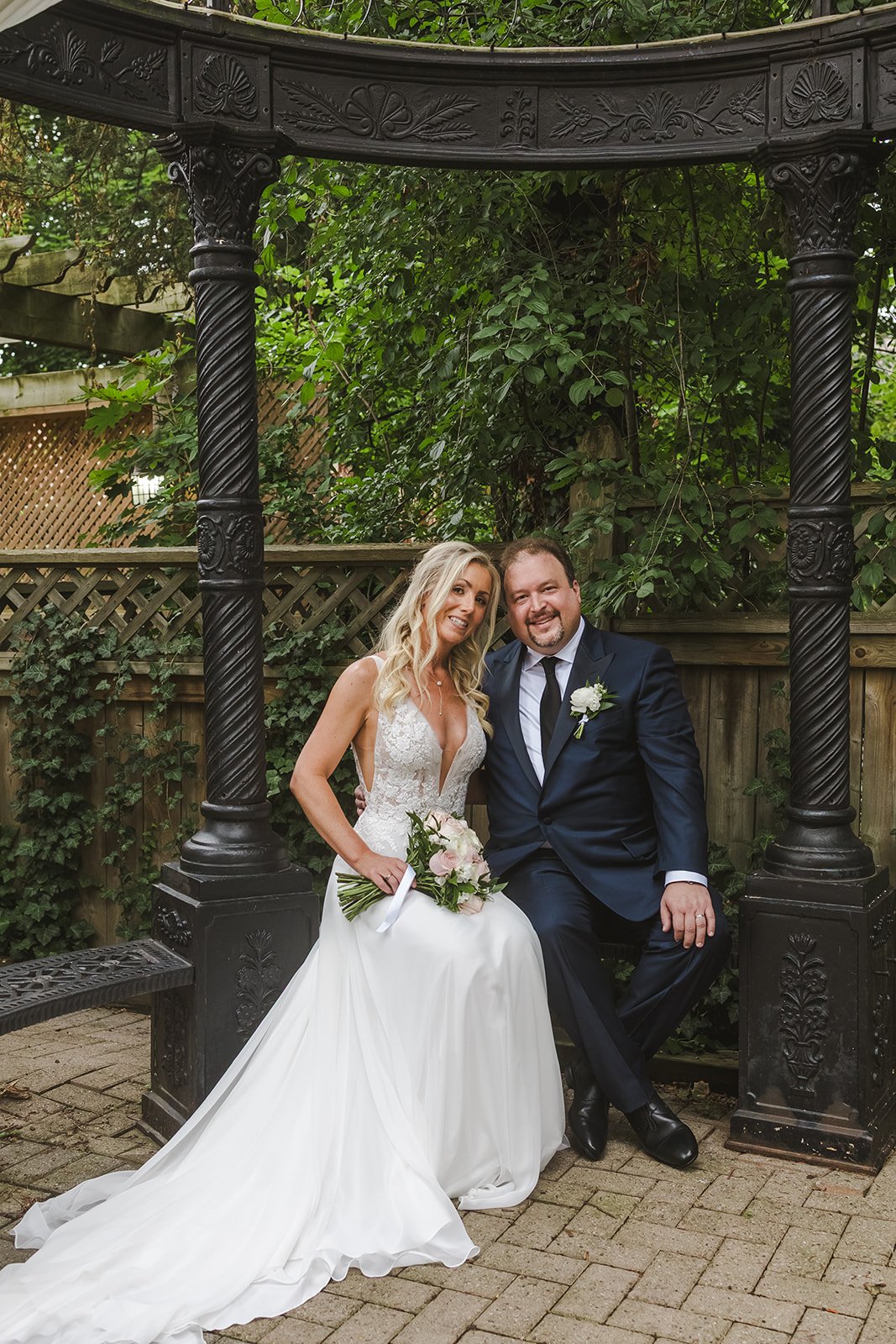 Bride and groom smiling while sitting  London, ON  Fedora Media.jpg