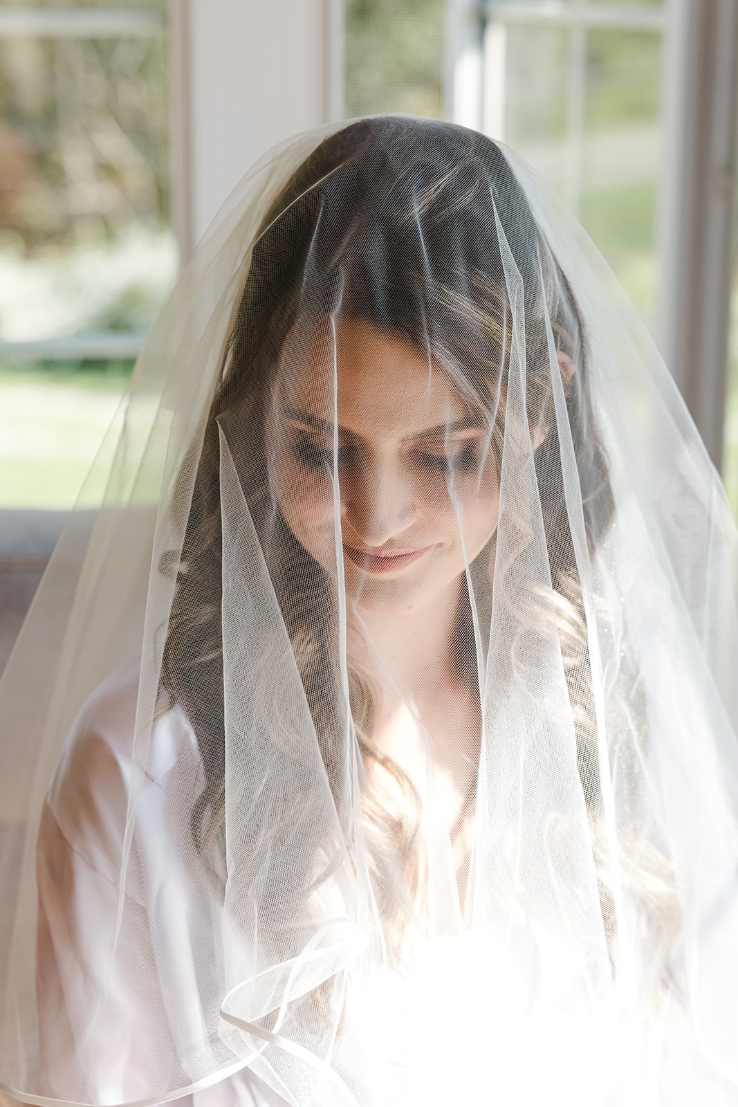 Bride under veil  Barn Swallows at Thatcher Farm  Fedora Media.jpg