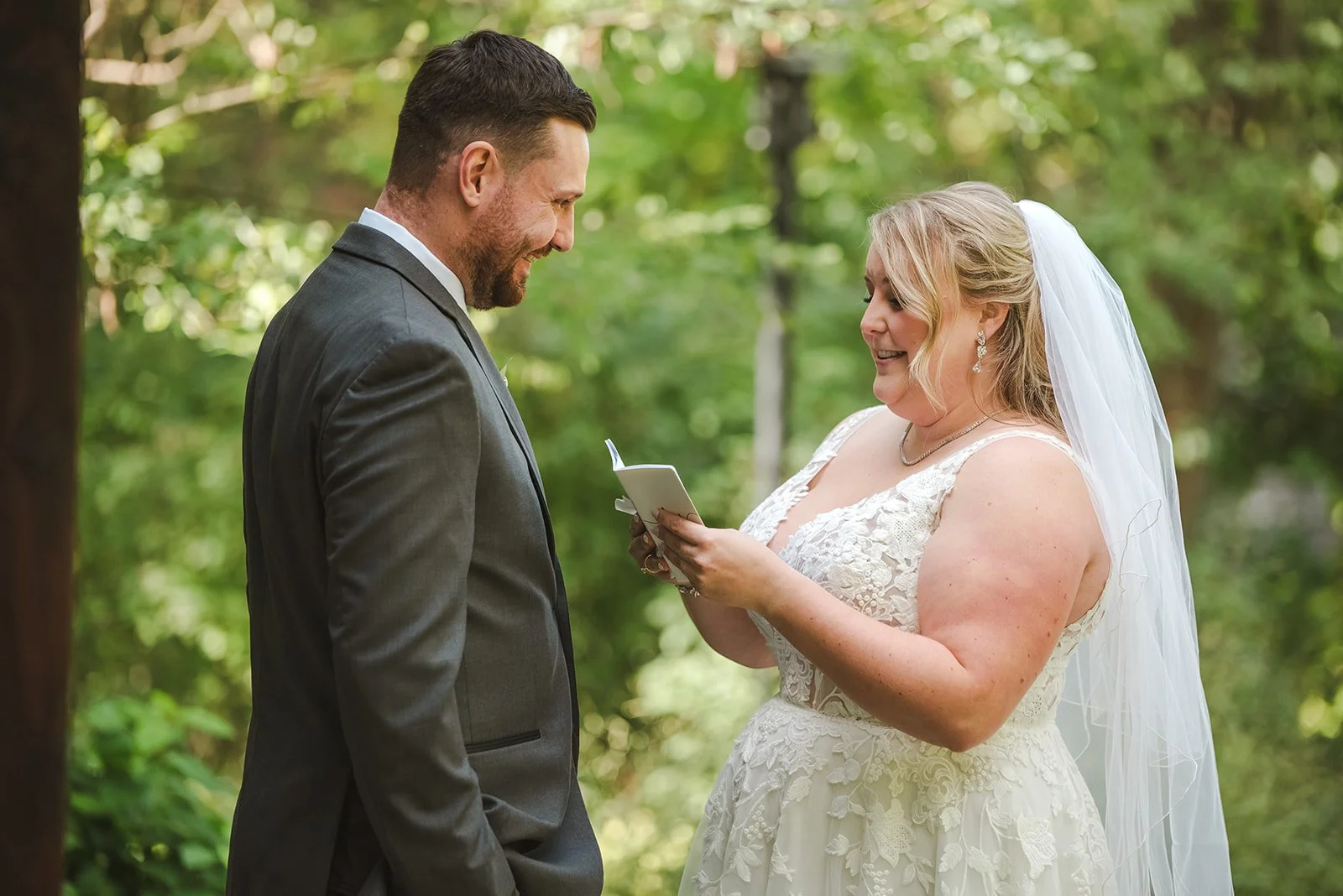 Bride reading private vows to groom during first look  Ancaster,  ON  Ancaster Mill  Fedora Media.jpg