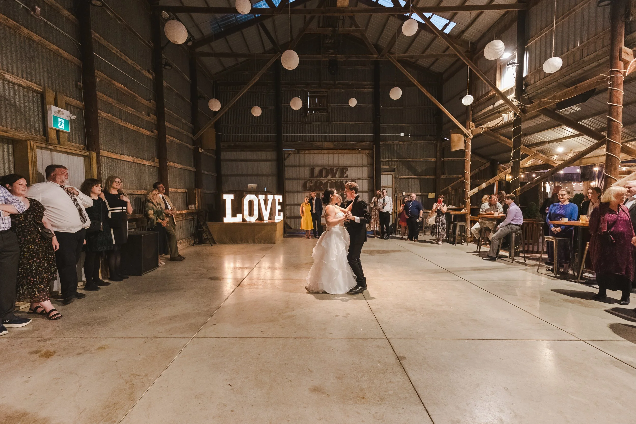 couples-photo-dancing-in-front-of-love-sign-fedora-media.jpg