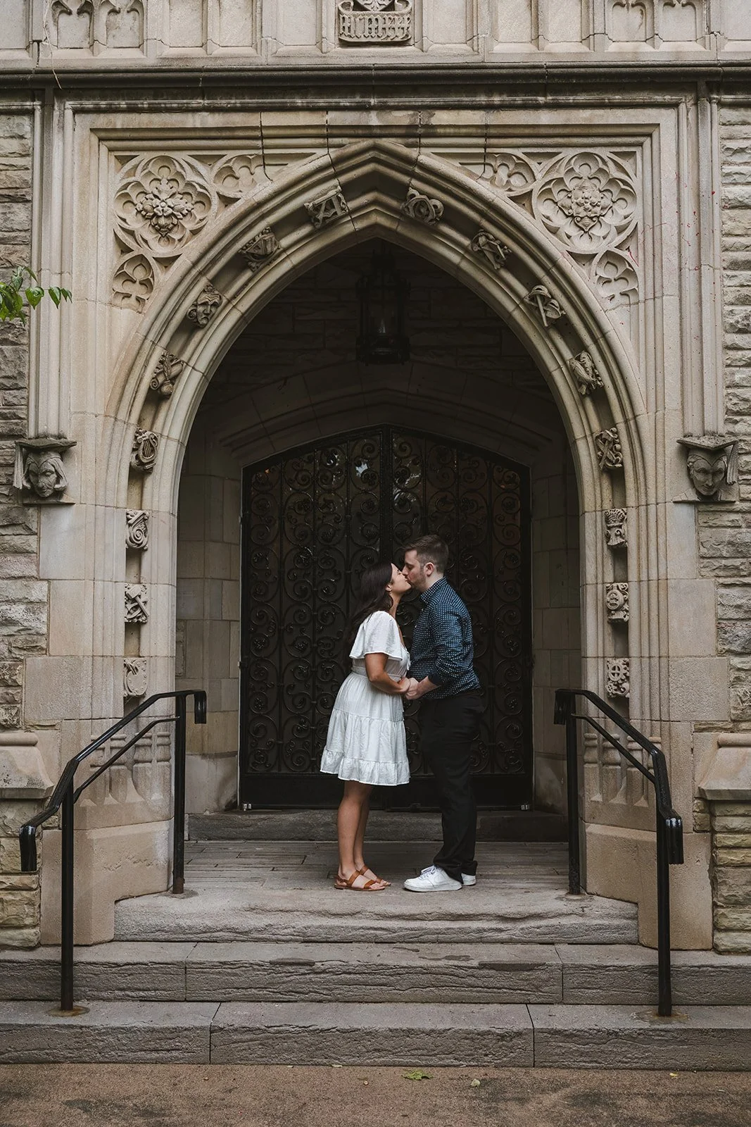 Engaged couple kissing in archway  Fedora Media.jpg