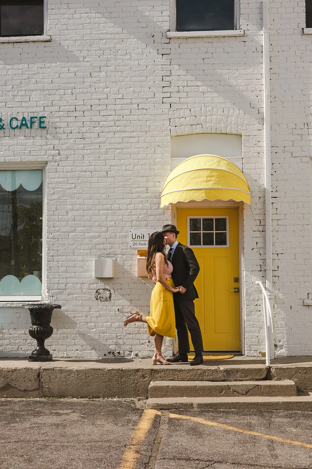 Couple kissing in front of yellow door  Ontario Engagement  Fedora Media.jpg
