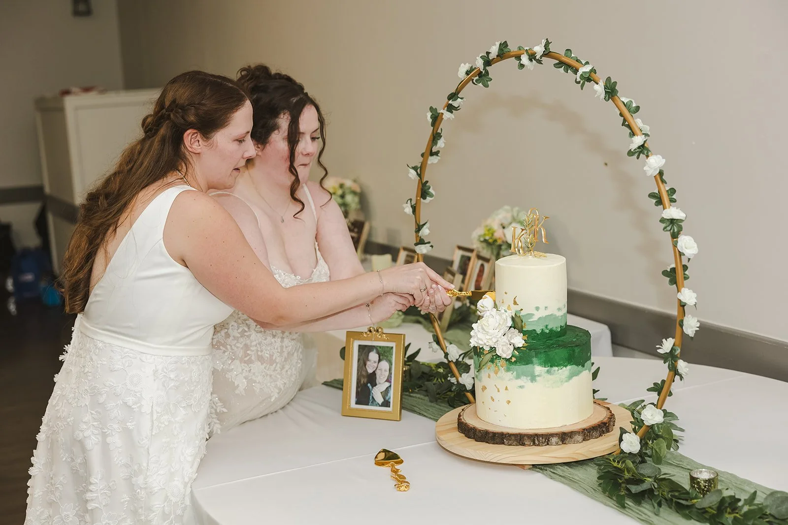 Brides cutting wedding cake together  Newfoundland Club  Cambridge, ON  Fedora Media.jpg