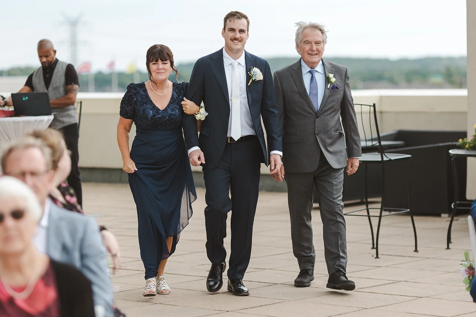 Groom walking down aisle with parents  Carmen's Hotel  Hamilton, ON  Fedora Media.jpg