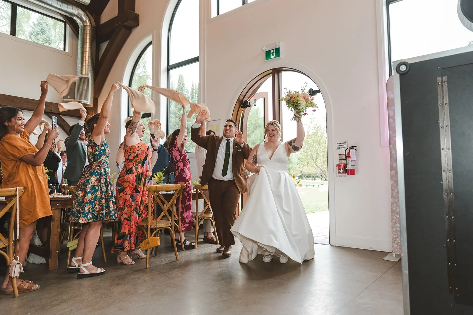 Bride and groom making an entrance waiving handkerchiefs  Erin Estates  Fedora Media.jpg