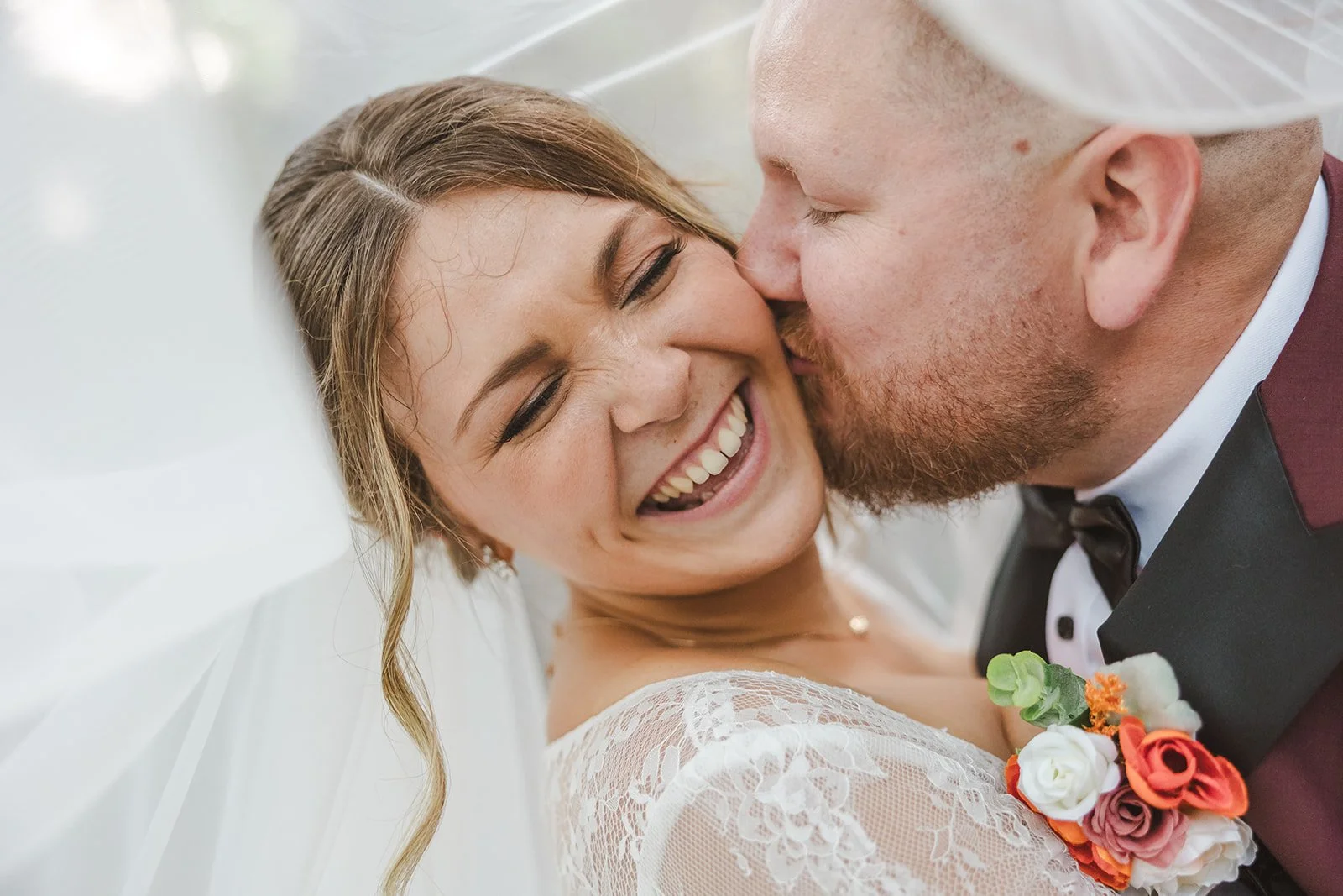 Groom kissing bride underneath veil  Erin Estates  Fedora Media.jpg