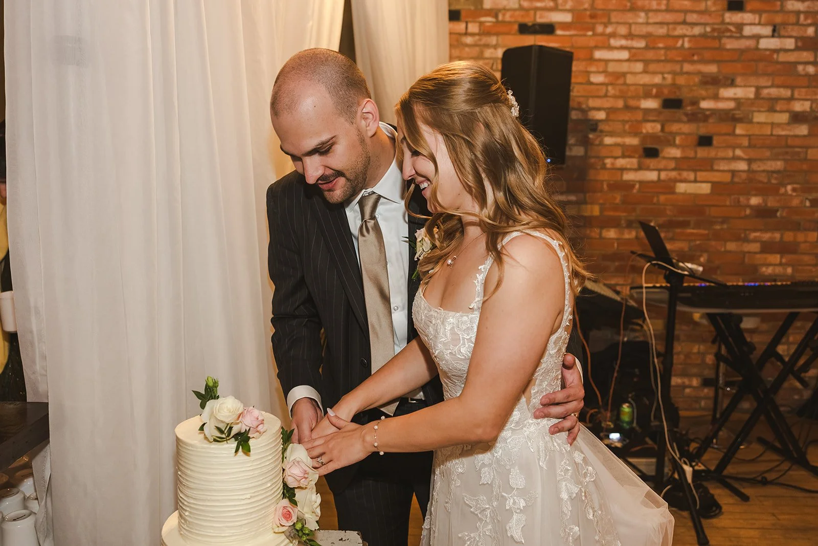 Bride and Groom cutting wedding cake  Paris, ON  Arlington Hotel  River's Edge  Fedora Media.jpg